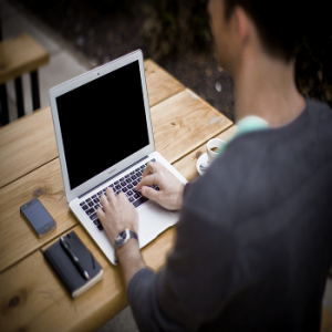 Man at computer writing article