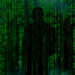 hacker-standing in shadows of data
