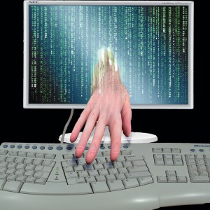 cyber thief stealing content, hand coming out of computer screen